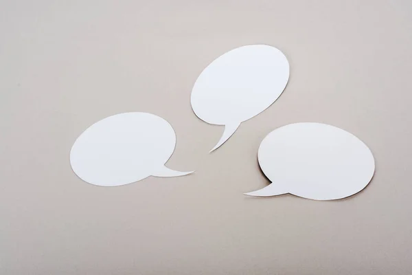 White blank speech bubbles with copy space on grey background — Stock Photo
