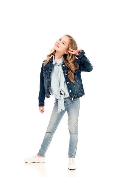 Full length view of kid in denim clothes showing peace sign on white — Stock Photo