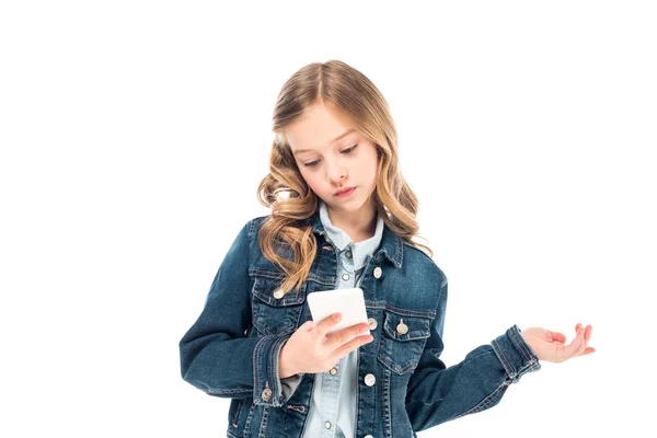 Concentrated kid in denim jacket using smartphone isolated on white — Stock Photo