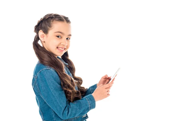 Happy kid in denim jacket using smartphone isolated on white — Stock Photo
