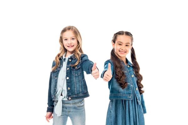 Two smiling kids in denim clothes showing thumbs up isolated on white — Stock Photo