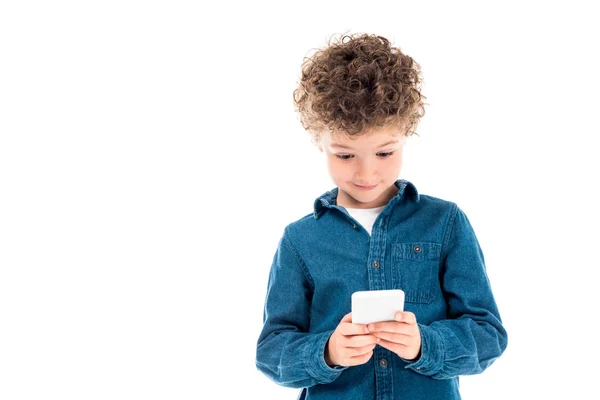 Милий кучерявий дитина в джинсовій сорочці за допомогою смартфона ізольовано на білому — стокове фото