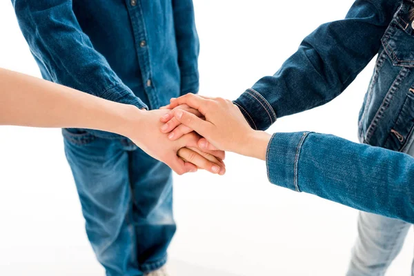 Partial view of kids holding hands isolated on white — Stock Photo