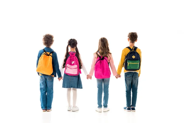 Vue arrière des écoliers avec des sacs à dos tenant les mains isolées sur blanc — Photo de stock
