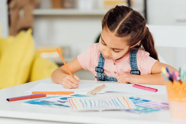 Selective focus of cute kid drawing on paper at home — Stock Photo