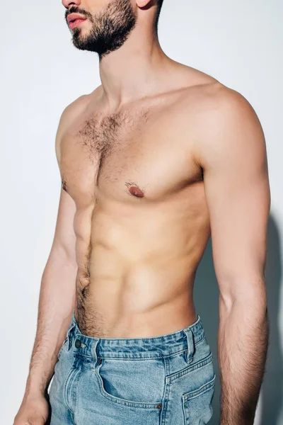 Cropped view of bearded and shirtless man standing on white — Stock Photo