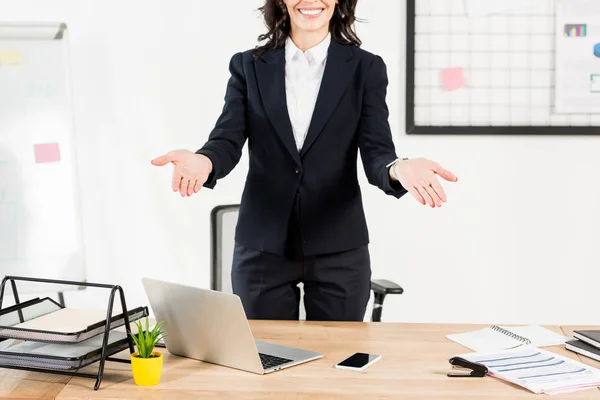 Corte vista de feliz morena recrutador sorrindo enquanto gestos no escritório — Fotografia de Stock