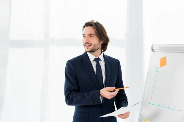 Fröhlicher Personalvermittler hält Papier in der Nähe von Whiteboard im Amt — Stockfoto