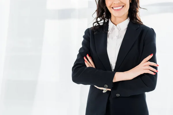 Cropped view of happy recruiter smiling while standing with crossed arms — Stock Photo