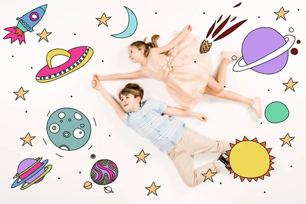 Top view of cheerful kids gesturing while flying in space — Stock Photo