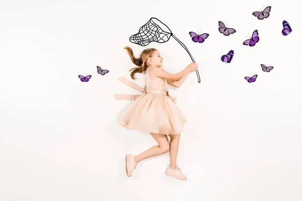 Top view of cheerful kid in pink dress holding butterfly net near butterflies on white — Stock Photo
