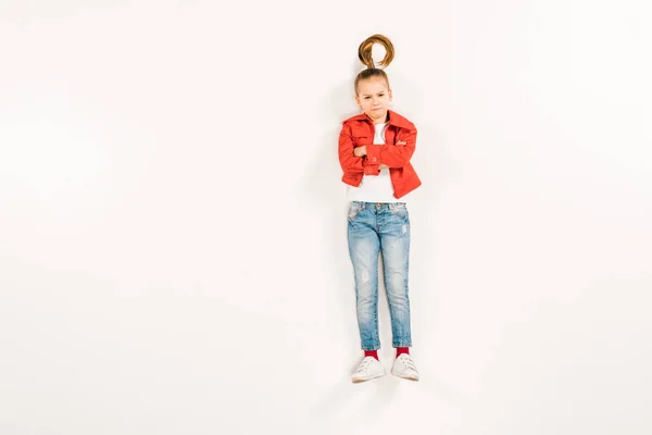 Top view of displeased kid with crossed arms on white — Stock Photo