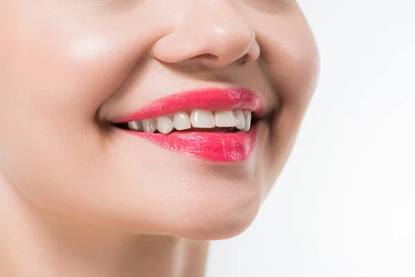 Vue recadrée de jeune femme aux lèvres roses souriant isolé sur blanc — Photo de stock