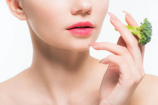 Cropped view of woman holding green and ripe broccoli isolated on white — Stock Photo