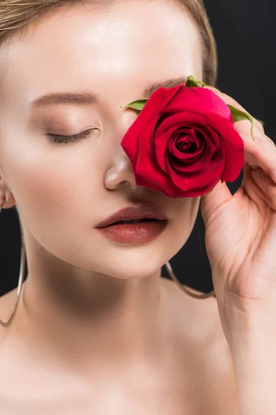 Selective focus of young woman holding red rose isolated on black — Stock Photo