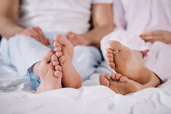 Vue recadrée des pieds nus du mari et de la femme dans la chambre — Photo de stock