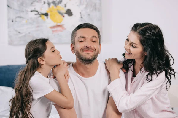 Cheerful kid with duck face near happy father and attractive mother at home — Stock Photo
