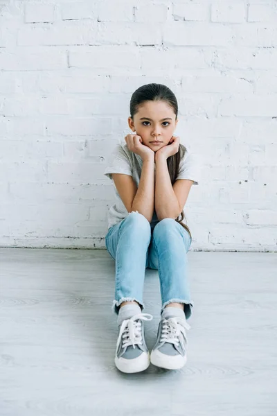 Upset preteen child sitting on floor at home — Stock Photo