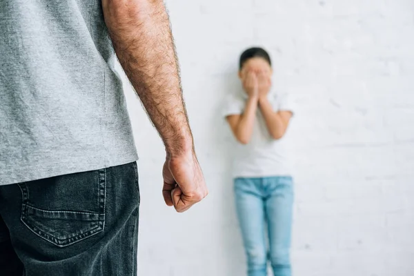 Partial view of abusive father and scared daughter — Stock Photo