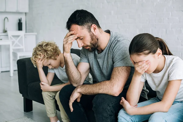 Two sad preteen children and father having conflict — Stock Photo