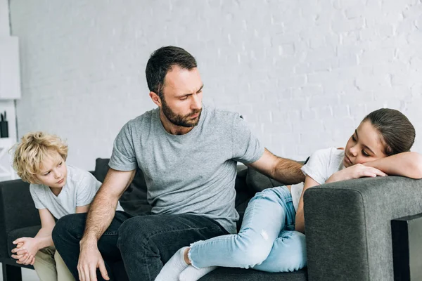 Two sad preteen children and father having conflict — Stock Photo