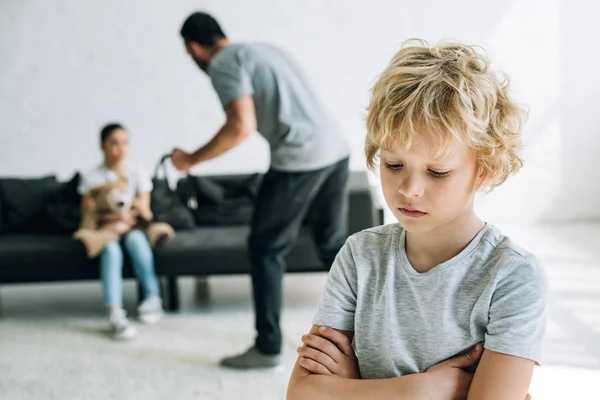 Sad children and abusive father holding belt at home — Stock Photo