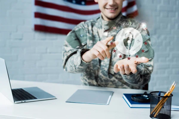 Cropped view of happy man in military uniform pointing with finger at cloud with padlock — Stock Photo