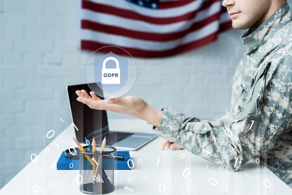 Cropped view of soldier gesturing near laptop with blank screen and virtual padlock — Stock Photo