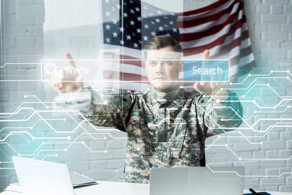 Man in military uniform pointing with fingers at address bar in office — Stock Photo