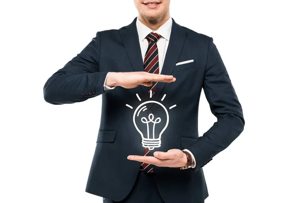 Vista cortada de empresário em desgaste formal gestos perto de lâmpada isolada em branco — Fotografia de Stock