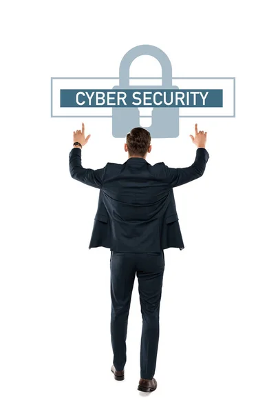 Back view of businessman pointing with fingers at cyber security lettering while standing isolated on white — Stock Photo