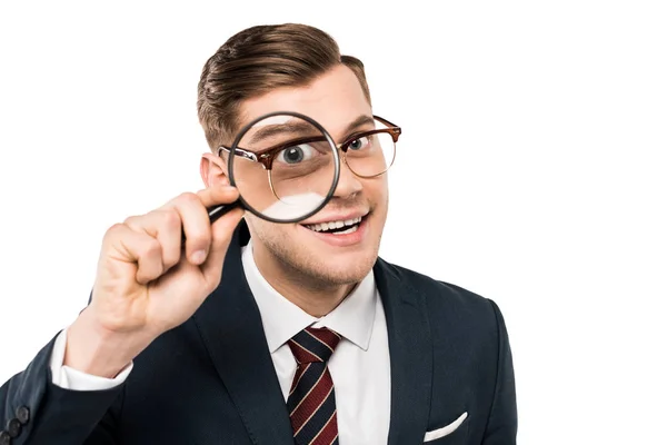Happy businessman holding magnifying glass near eye isolated on white — Stock Photo