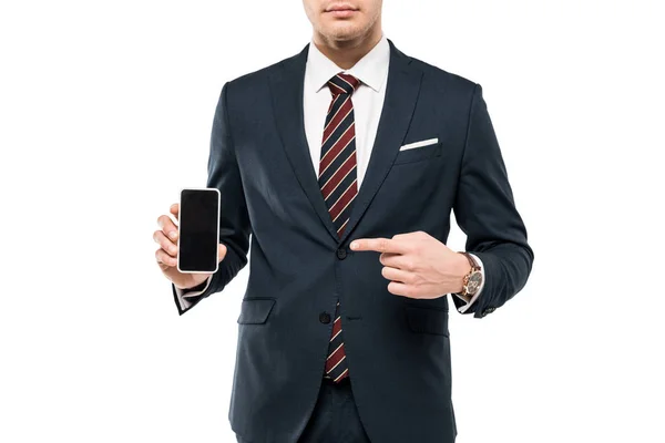 Cropped view of businessman in suit pointing with finger at smartphone with blank screen isolated on white — Stock Photo