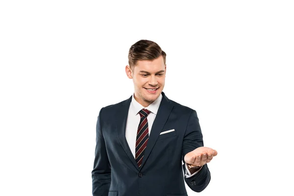 Alegre hombre de negocios en traje mirando a mano aislado en blanco - foto de stock