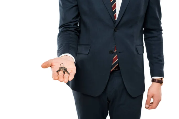 Cropped view of businessman holding keys in hand isolated on white — Stock Photo