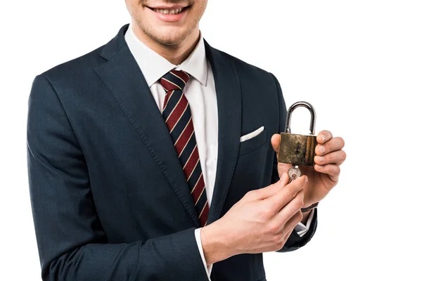 Cropped view of happy businessman in suit holding keys and padlock isolated on white — Stock Photo