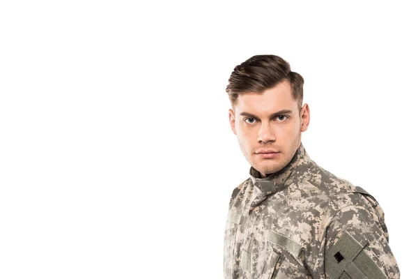 Serious and handsome soldier in uniform looking at camera isolated on white — Stock Photo