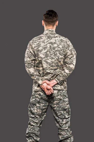 Back view of soldier standing isolated on grey — Stock Photo