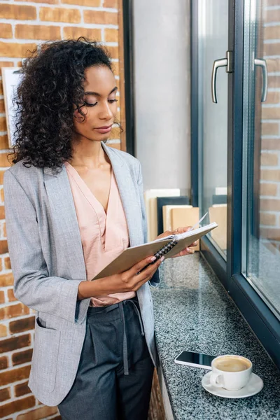 Beautiful Casual businesswoman holding notebook in loft office — Stock Photo