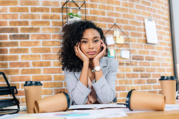 Втомилася афроамериканка Випадкова бізнес-леді за столом з кавою, щоб піти чашки в офіс — стокове фото