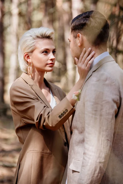 Selective focus of stylish woman touching man face — Stock Photo