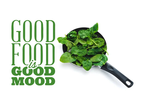 Foglie di spinaci freschi in padella su sfondo bianco vicino buon cibo è di buon umore lettering verde — Foto stock