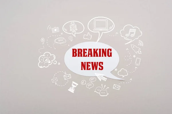 White speech bubble with red breaking news lettering and social media illustration on grey background — Stock Photo