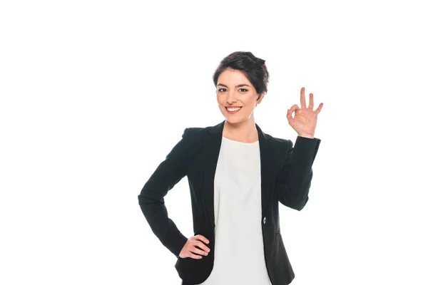 Cheerful mixed race businesswoman showing ok gesture isolated on white — Stock Photo