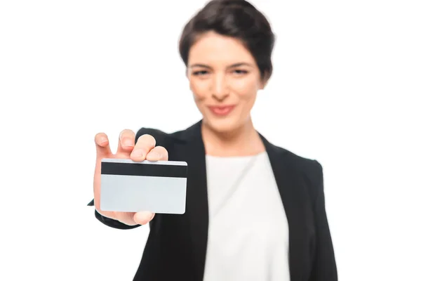 Selective focus of smiling mixed race businesswoman showing credit card isolated on white — Stock Photo