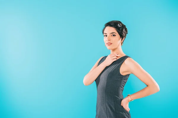 Attractive mixed race woman posing at camera with hand on hip isolated on blue — Stock Photo