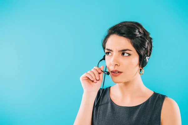 Thoughtful mixed race call center operator in headset looking away isolated on blue — Stock Photo