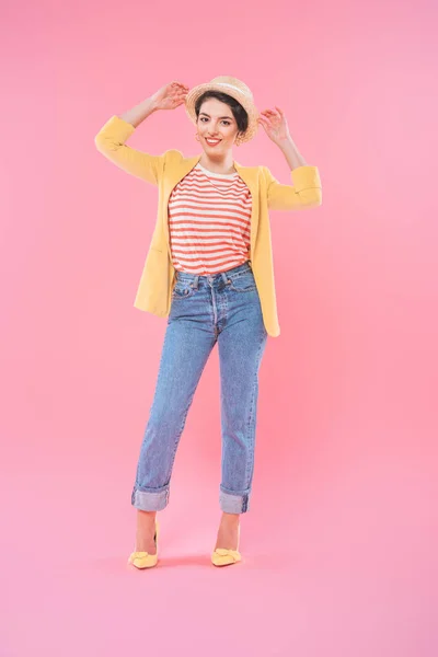 Attractive mixed race woman in bright clothing posing at camera on pink background — Stock Photo