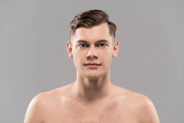 Vue de face de nu beau jeune homme regardant caméra isolé sur gris — Photo de stock