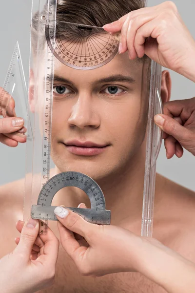 Visão recortada de cirurgiões plásticos que medem a face com réguas e protratores isolados em cinza — Fotografia de Stock